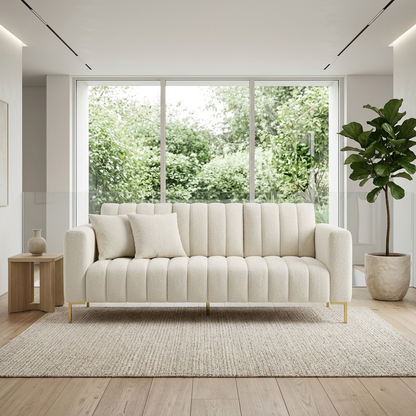 Cream boucle fluted sofa with gold legs styled in a room setting