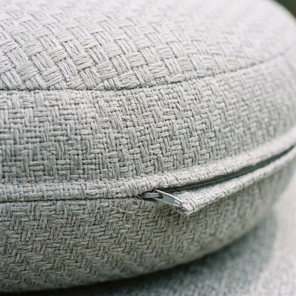 Close up of grey woven cushion fabric and zip detail