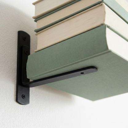 Close up showing how the floating bookshelf bracket holds the book