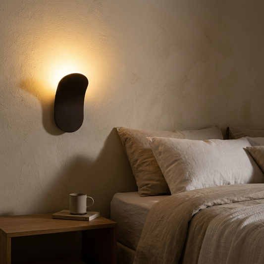 Minimalist LED wall lamp glowing beside a bed at night